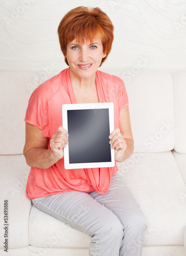 Photo: Mature woman with tablet pc Mature woman with tablet pc