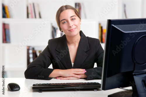 Photo: Businesswoman At Office Desk Businesswoman At Office Desk
