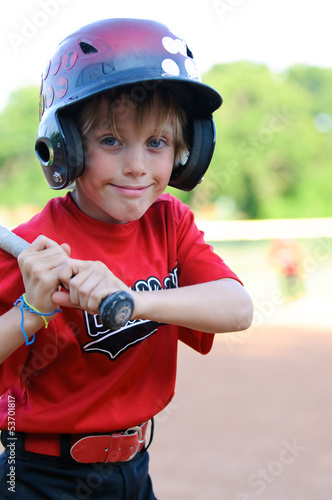 Photo: Happy baseball boy in helmet up close. Happy baseball boy in helmet up close.