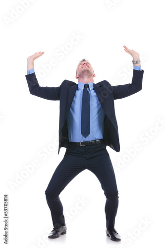 Photo: business man raises something imaginary business man raises something imaginary
