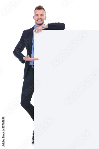Photo: business man presents empty board business man presents empty board