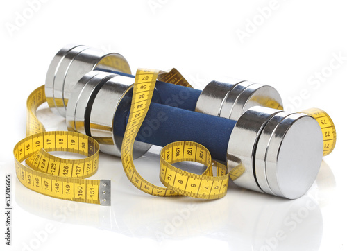 Photo: Dumbbells and a measuring tape over white Dumbbells and a measuring tape over white