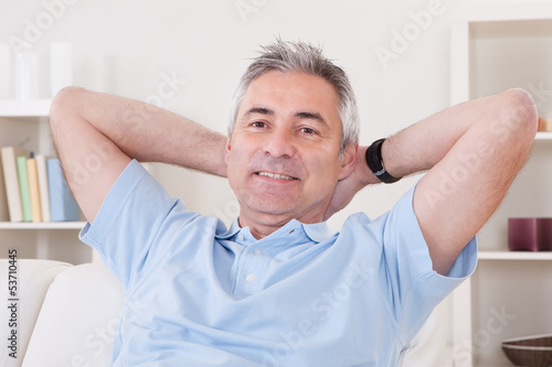 Photo: Mature Man Sitting On Sofa Mature Man Sitting On Sofa