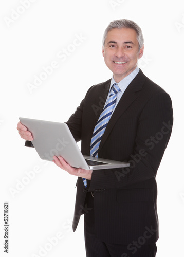 Photo: Happy Mature Businessman Using Laptop Happy Mature Businessman Using Laptop
