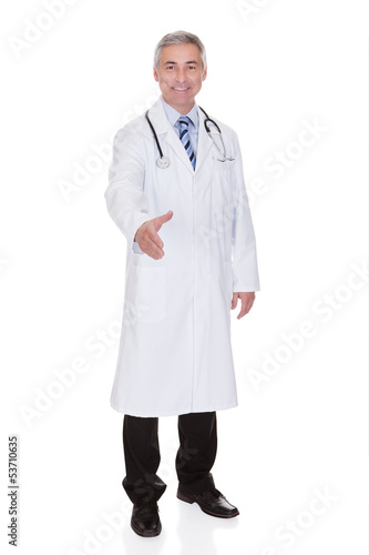 Photo: Portrait Of Happy Mature Male Doctor Offering Handshake Portrait Of Happy Mature Male Doctor Offering Handshake