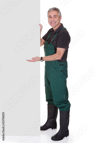 Photo: Mature Male Gardner Holding Placard Mature Male Gardner Holding Placard