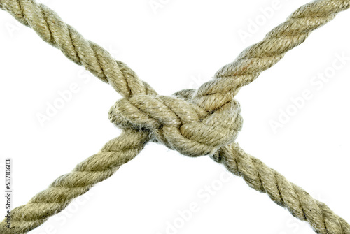 Photo: The rope tied in a knot on a white background. The rope tied in a knot on a white background.