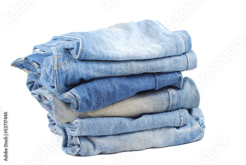 Photo: Stack of blue jeans on white background Stack of blue jeans on white background