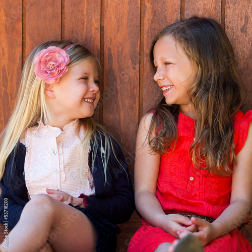 Photo: Two girlfriends having conversation. Two girlfriends having conversation.