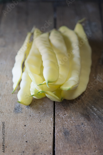 Photo: Yellow kidney beans on wooden table Yellow kidney beans on wooden table
