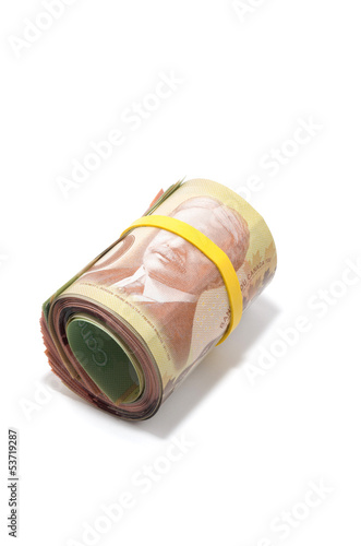 Photo: Roll of Canadian banknotes with 100 dollars at the surface Roll of Canadian banknotes with 100 dollars at the surface