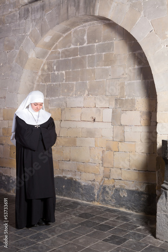 Photo: Young nun in old church Young nun in old church