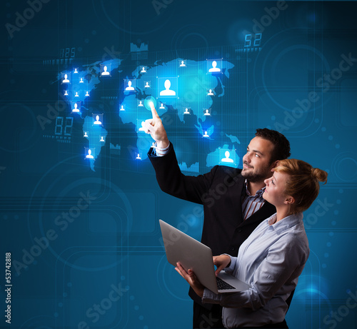 Photo: Young couple choosing from social network map Young couple choosing from social network map
