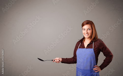 Photo: Pretty woman holding a spoon Pretty woman holding a spoon