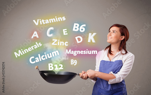 Photo: Young woman cooking vitamins and minerals Young woman cooking vitamins and minerals