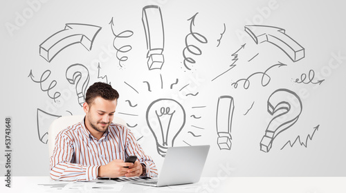 Photo: Young businessman brainstorming with drawn arrows and symbols Young businessman brainstorming with drawn arrows and symbols
