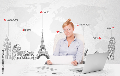 Photo: Beautiful businesswoman with world map and major landmarks of th Beautiful businesswoman with world map and major landmarks of th