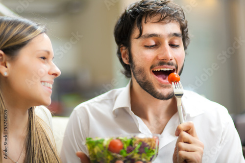 Photo: Lovely couple eating a salad Lovely couple eating a salad