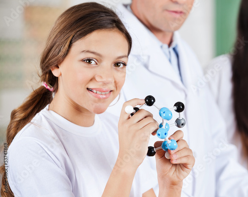 Photo: Teenage Girl Holding Molecular Structure Teenage Girl Holding Molecular Structure