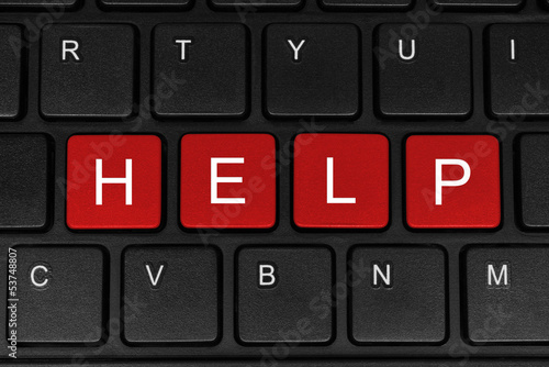 Photo: The word help made of four red buttons The word help made of four red buttons