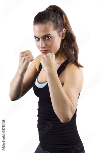 Photo: young woman in fighting stance on white background young woman in fighting stance on white background