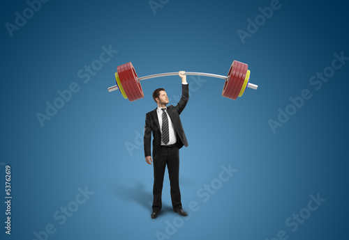 Photo: businessman holding barbell businessman holding barbell