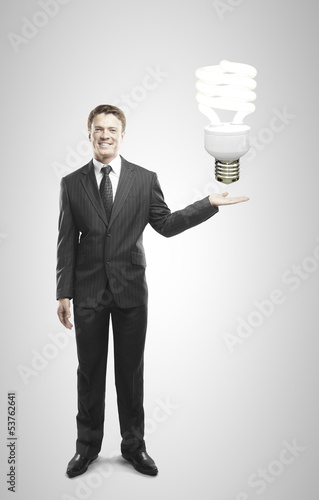 Photo: businessman holding lamp businessman holding lamp
