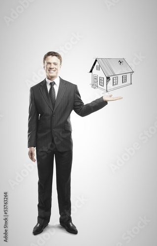 Photo: businessman holding house businessman holding house
