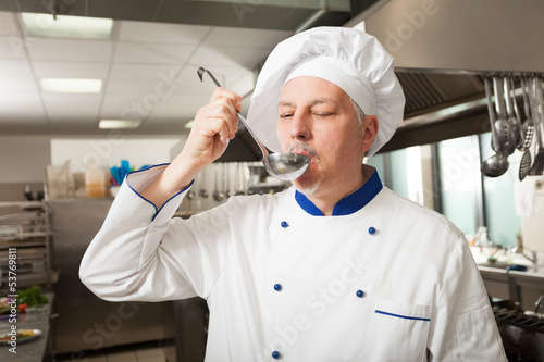 Photo: Portrait of a chef in his kitchen Portrait of a chef in his kitchen