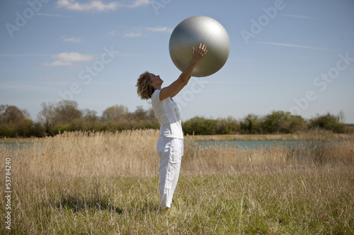 Photo: A mature woman holding an exercise ball A mature woman holding an exercise ball