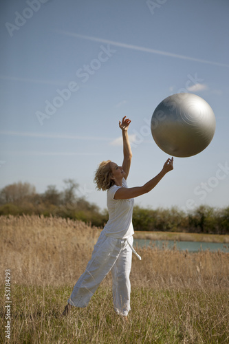 Photo: A mature woman catching an exercise ball A mature woman catching an exercise ball