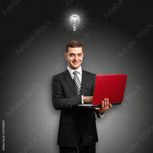 Photo: Idea Concept male in suit with laptop in his hands Idea Concept male in suit with laptop in his hands