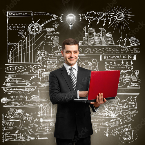 Photo: Idea Concept male in suit with laptop in his hands Idea Concept male in suit with laptop in his hands