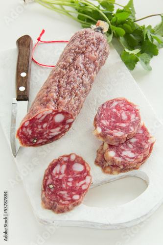 Photo: Sliced uncooked jerked sausages. Sliced uncooked jerked sausages.