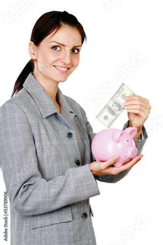 Photo: Young beautiful woman standing with piggy bank (money box) Young beautiful woman standing with piggy bank (money box)