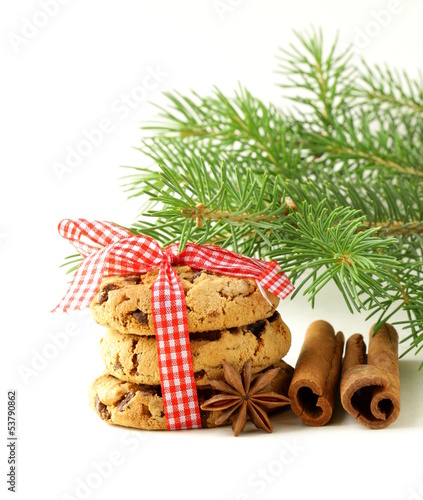 Photo: Christmas cookies with red ribbon and green fir tree branches Christmas cookies with red ribbon and green fir tree branches