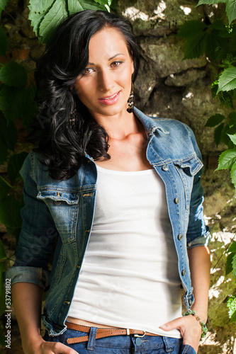 Photo: Beautiful young woman in a park Beautiful young woman in a park