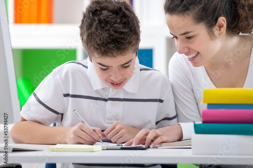 Photo: Sister teaching brother Sister teaching brother