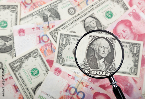 Photo: Focusing on US dollar note against US and Chinese currencies Focusing on US dollar note against US and Chinese currencies