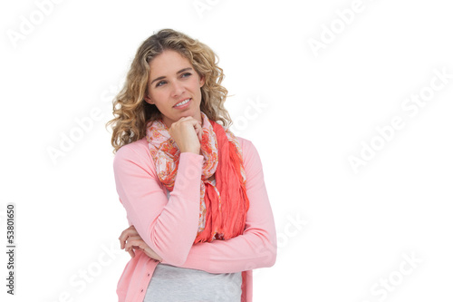 Photo: Blonde thoughtful woman smiling while touching her chin Blonde thoughtful woman smiling while touching her chin