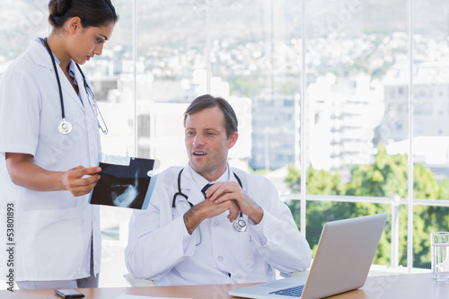 Photo: Group of doctors working on a x ray Group of doctors working on a x ray