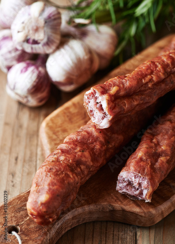 Photo: Dried sausage on wooden chopping board (polish cuisine) Dried sausage on wooden chopping board (polish cuisine)
