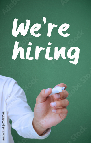 Photo: Businessman writing with a marker we're hiring Businessman writing with a marker we're hiring