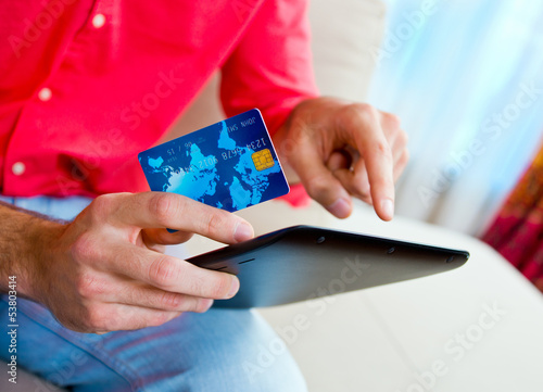 Photo: man hand credit card and tablet man hand credit card and tablet