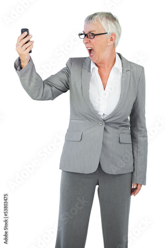 Photo: Furious businesswoman screaming during a call Furious businesswoman screaming during a call