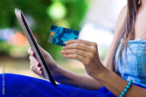 Photo: woman hand credit card and tablet woman hand credit card and tablet
