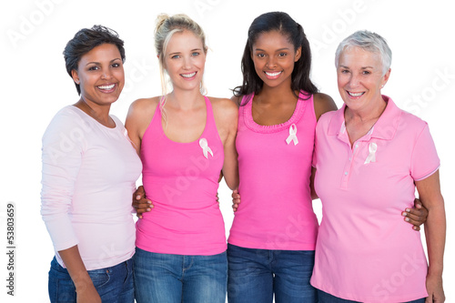Photo: Smiling women wearing pink tops and breast cancer ribbons Smiling women wearing pink tops and breast cancer ribbons