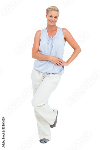 Photo: Woman smiling with hand on hip looking at camera Woman smiling with hand on hip looking at camera