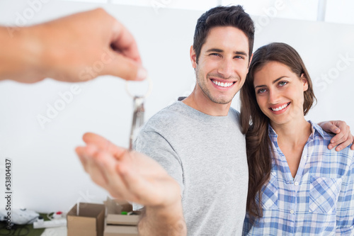 Photo: Happy man being given a house key Happy man being given a house key