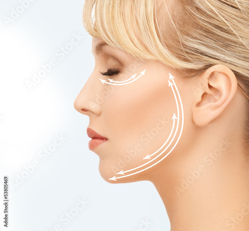 Photo: beautiful young woman face with arrows beautiful young woman face with arrows